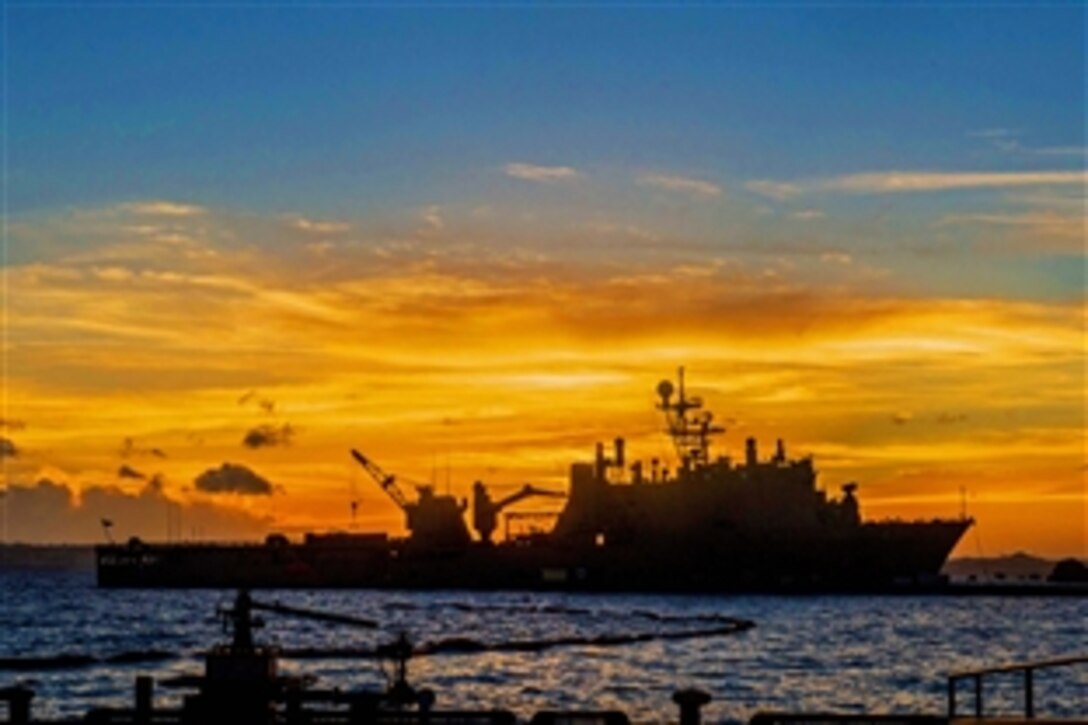 The sun sets behind the USS Germantown in Okinawa, Japan, June 24, 2013. The Germantown is part of the Bonhomme Richard Amphibious Ready Group and will be participating in routine joint force operations in the U.S. 7th Fleet area of responsibility. 