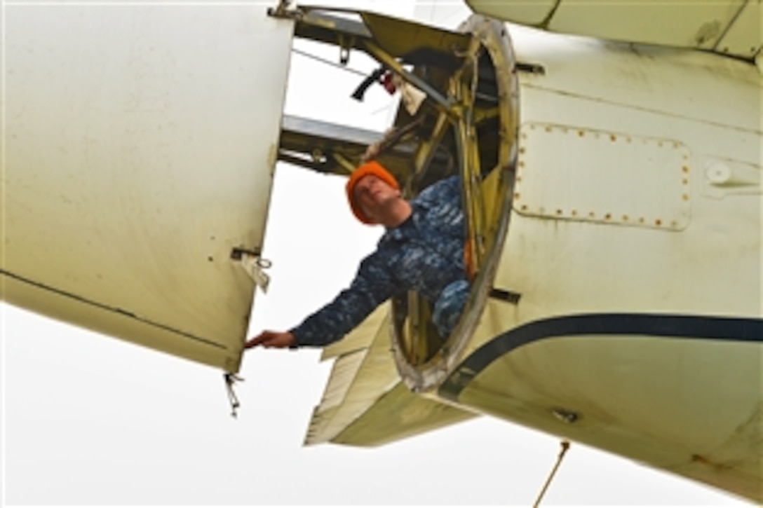 U.S. Navy Petty Officer 2nd Class Kyle Ashford checks for weather deterioration on a retired P-3 Orion aircraft at the Misawa Aviation and Science Museum in Misawa, Japan, June 26, 2013. Aircraft Intermediate Maintenance Detachment Misawa sailors are renovating the aircraft after more than a decade of exposure to northern Japan winters. 