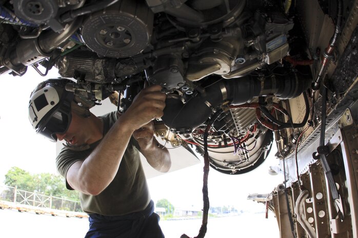 Sgt. Vincent T. Erzen, A fixed-wing aircraft mechanic with Marine All-Weather Fighter Attack Squadron 242, replaces a bleed air regulator in an F/A-18D Hornet at Clark Air Base, Republic of the Philippines June 14, during Exercise Haribon Tempest 2013.