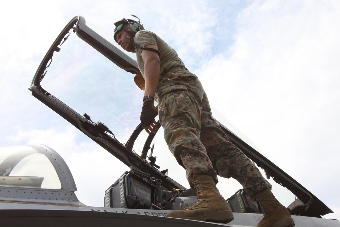 Lance Cpl. Demoin T. Brown, An aircraft electrical systems technician with Marine All-Weather Fighter Attack Squadron 242, stands on top of an F/A-18D Hornet after conducting inspections June 12, during Exercise Haribon Tempest 2013. The focus of this weeklong training exercise is to improve tactical-level military proficiency and enhance U.S.-Philippine interoperability and combined abilities. Training activities enabled servicemembers to get to know one another, train together and provide assistance to local communities.