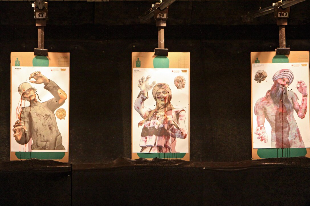 Zombie targets hang covered in bullet holes and fake blood during the Headquarters and Headquarters Squadron Zombie Shoot, which took place in the Indoor Small Arms Range, June 18-20, 2013. Maj. Elizabeth Pham, H&HS executive officer, said she organized the event for junior Marines as an opportunity to have an event of their own and introduce them to the Beretta M9 pistol.