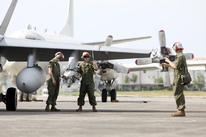 Lance Cpl. John T. Page, right, gives orders through hand and arms signals to Sgt. Ian R. Wheeler, left, and Lance Cpl. William F. Burch to arm an F/A-18D Hornet for flight at Clark Air Base, Republic of the Philippines, June 11 during Exercise Haribon Tempest 2013. All three Marines are aircraft ordnance technicians with Marine All-Weather Fighter Attack Squadron 242.