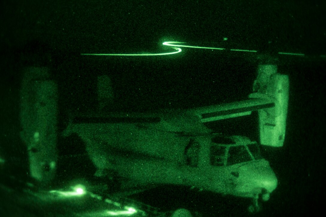 An MV-22B Osprey assigned to Marine Medium Tiltorotor Squadron (VMM) 266 (Reinforced), 26th Marine Expeditionary Unit (MEU), lands aboard the USS Kearsarge (LHD 3), during nighttime flight operations at sea, June 27, 2013. The 26th MEU is a Marine Air-Ground Task Force forward-deployed to the U.S. 5th Fleet area of responsibility aboard the Kearsarge Amphibious Ready Group serving as a sea-based, expeditionary crisis response force capable of conducting amphibious operations across the full range of military operations. (U.S. Marine Corps photograph by Sgt. Christopher Q. Stone, 26th MEU Combat Camera/Released)