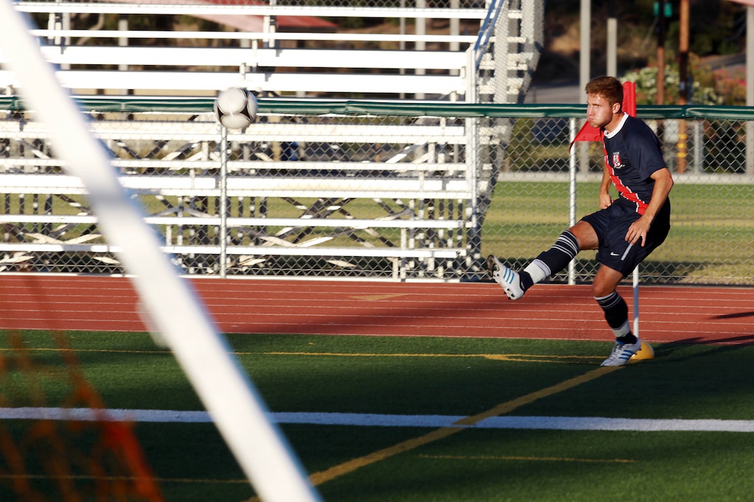 Air Force 2nd Lt. Kevin Durr crosses the ball in from a corner kick in the first half of their game against Bethesda University held at the 11-area field here June 24. Durr is a striker for Team USA Armed Forces. Team USA Armed Forces is scheduled to play in the 1st Annual Military World Cup held in Baku, Azerbaijan.