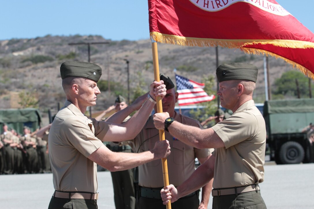 Lieutenant Col. Christeon C. Griffin, the outgoing commanding officer of 3rd Battalion, 5th Marine Regiment, hands the battalion colors to Lt. Col. Robert C. Rice, the battalion's incoming commanding officer, during a change of command ceremony at the Camp San Mateo parade deck here, June 26, 2013. The passing of the colors signified the transfer of authority and responsibility from one commander to the next.
(U.S. Marine Corps photo by Sgt. Jacob H. Harrer)