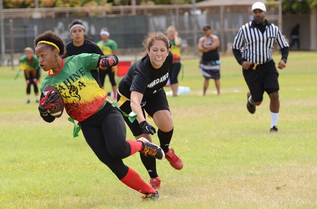 Wahine Koa player Brittany Robinson tries to advance down the field with the ball during a Hawaii Gridiron League flag football game at Kapiolani Park, June 23, 2013. (U.S. Marine Corps photo by Kristen Wong)