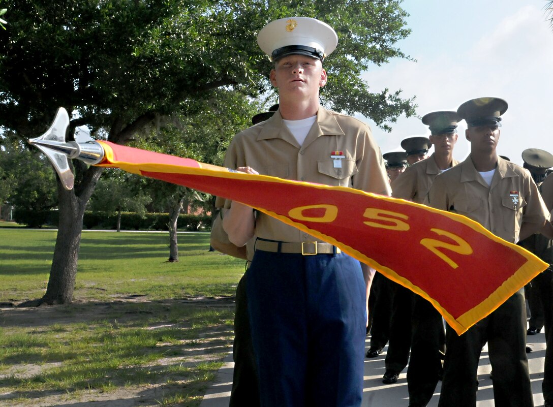 MRCD Parris Island - Private First Class Ryan L. Pack, honor graduate of platoon 2052, presents the guidon during graduation aboard Parris Island, S.C., June 28, 2013. Pack is a native of Duncan, S.C., and recruited by Staff Sgt. Joshua B. Stafford, recruiter from  Recruiting Station Baton Rouge. Pack will be able to enjoy some much deserved leave as he prepares for Marine Combat Training in Camp Geiger, N.C. (U.S. Marine Corps photo by Cpl. Gabrielle Bustos) 

