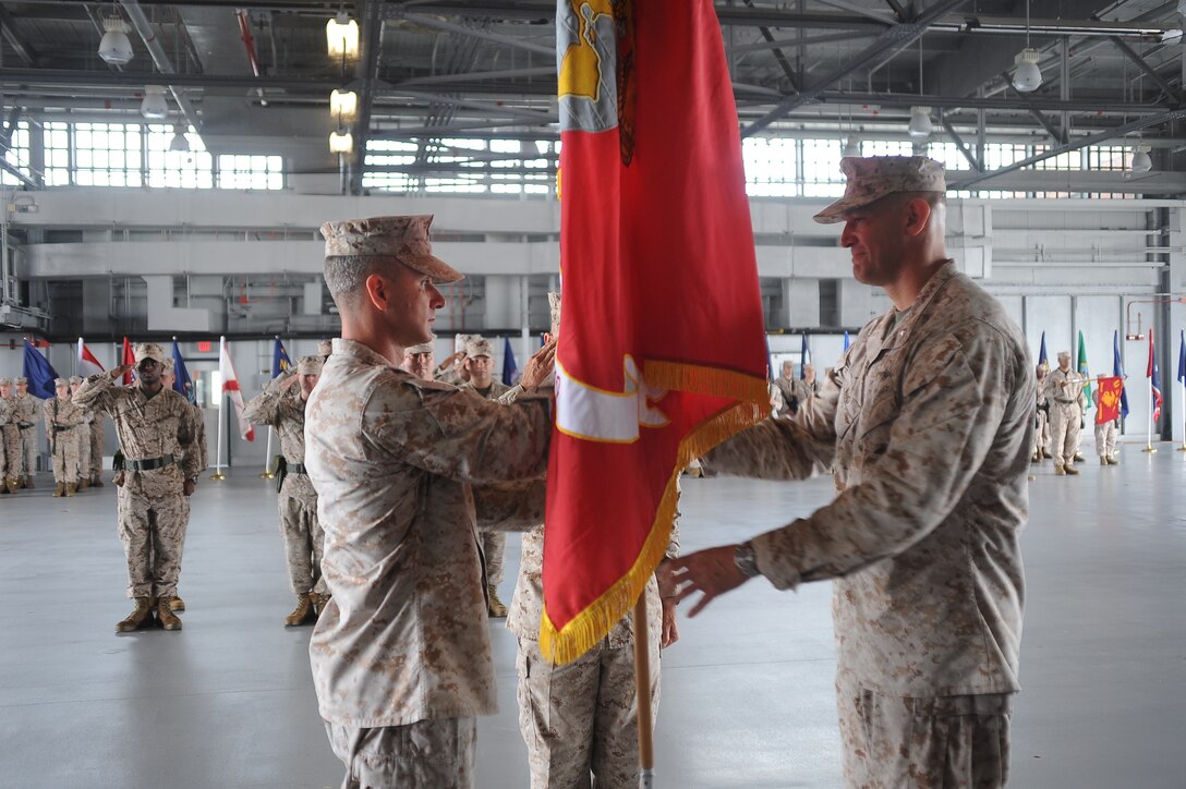 Lt. Col. Gaines L. Ward, outgoing commanding officer, Marine Corps Air Facility Quantico, passes the colors to Lt. Col. Vincent J. Cuiccoli, incoming commanding officer MCAF Quantico, on June 27, 2013. Cuiccoli has accumulated over 2,400 hours as a naval aviator. Prior to taking command of MCAF Quantico, Cuiccoli served as the executive officer of Marine Aircraft Group 39 in California.