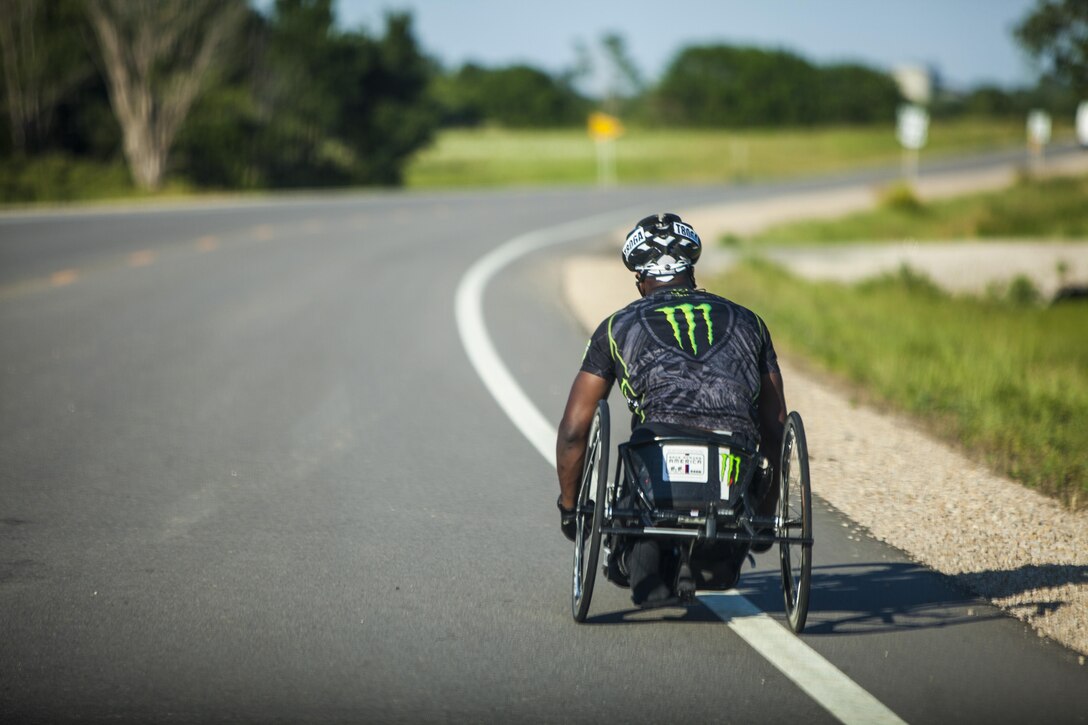 Anthony Robinson, a cyclists and wounded warrior with Team Walter Reed Bethesda from Baton Rouge, La., cycles through the west during the 32nd Annual Race Across America, June 18. Team Walter Reed Bethesda was formed to help wounded veterans rebuild themselves and regain their warrior spirits.