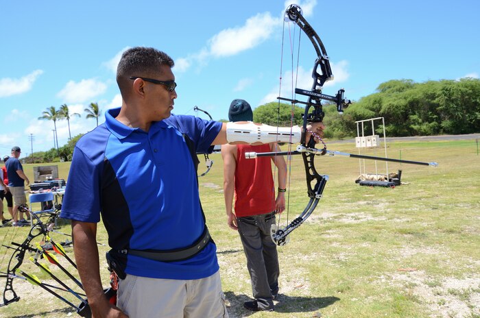 Master Sgt. Hector Hernandez, a wounded warrior with Wounded Warrior Battalion West - Detachment Hawaii takes a practice aim at a target while shooting at the Marine Corps Community Services Archery Range, June 26, 2013. The wounded warriors and staff members of the detachment attended a special course to be certified as level one air rifle coaches and level one archery coaches. (U.S. Marine Corps photo by Kristen Wong)