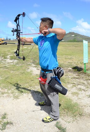 Capt. Chris McGleinnaiss, a wounded warrior with Wounded Warrior Battalion West - Detachment Hawaii, prepares to launch an arrow at the Marine Corps Community Services Archery Range, June 26, 2013. (U.S. Marine Corps photo by Kristen Wong)