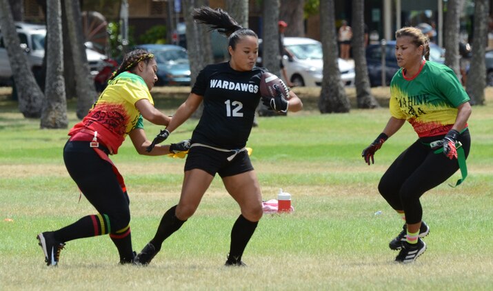 Wahine Koa players Dee Hawkins (left) and Bel Fleming try to stop Wardawgz corner Jenna Folks as she attempts to advance down the field with the ball during a Hawaii Gridiron League flag football game at Kapiolani Park, June 23, 2013. (U.S. Marine Corps photo by Kristen Wong)
