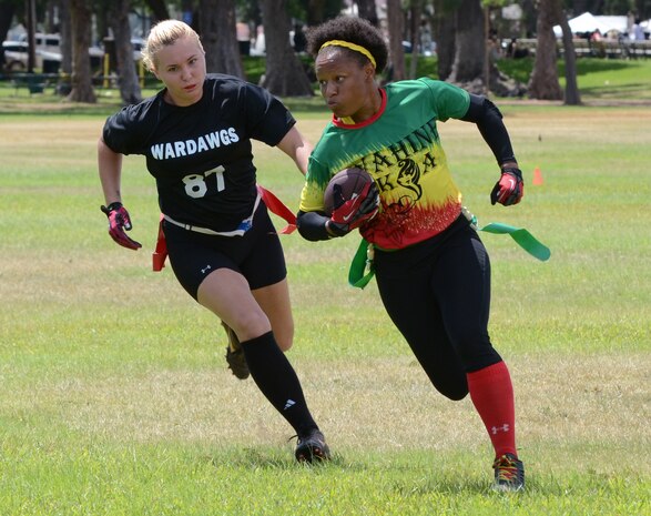 Wahine Koa player Brittany Robinson tries to advance down the field with the ball with Wardawgz corner Crystal Herrera pursuing her during a Hawaii Gridiron League flag football game at Kapiolani Park, June 23, 2013. (U.S. Marine Corps photo by Kristen Wong)