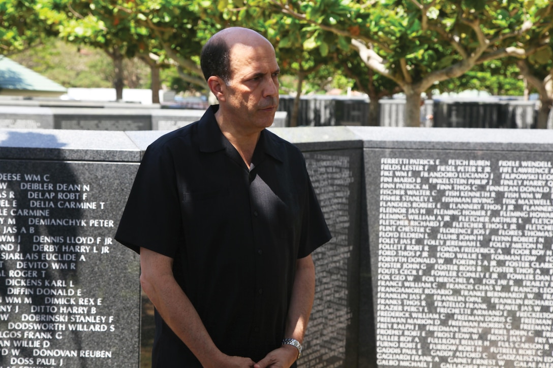 While standing in front of the walls of the Cornerstone of Peace, John V. Roos speaks to attendees at a ceremony prior to the 2013 Okinawa Memorial Service for All War Dead June 23 at the Okinawa Prefectural Peace Memorial Park in Itoman. “You can’t help but be moved by (more than) 12,000 American names inscribed in these walls, along with the thousands of others who lost their lives in bitter conflict during the Battle of Okinawa,” said Roos, the U.S. Ambassador to Japan.(U.S. Marine Corps photo by Cpl. Matthew Manning/Released)