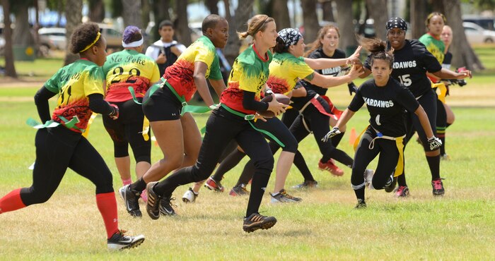 Wardawgz players chase Wahine Koa players as they try to advance down the field with the ball during a Hawaii Gridiron League flag football game at Kapiolani Park, June 23, 2013. (U.S. Marine Corps photo by Kristen Wong)