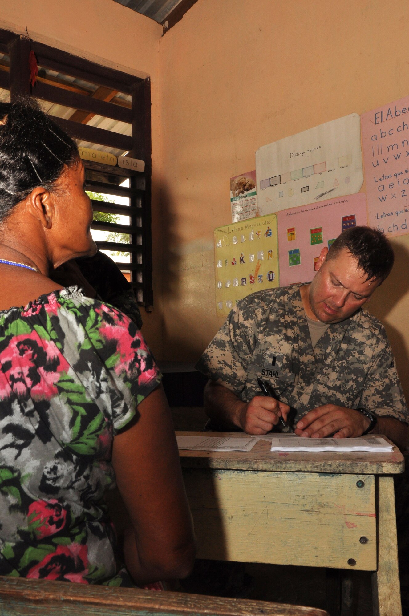 U.S. Army 1st Lt. Jason Stahl, Joint Task Force-Bravo Medical Element registered nurse, speaks to a villager about her alignments, during a medical readiness training exercise held in the remote region of Bara Patuca, Gracias a Dios, June 25-26, 2013. During the two-day exercise the medical team visited with more than 910 patients with alignments ranging from a common cold to pneumonia. 