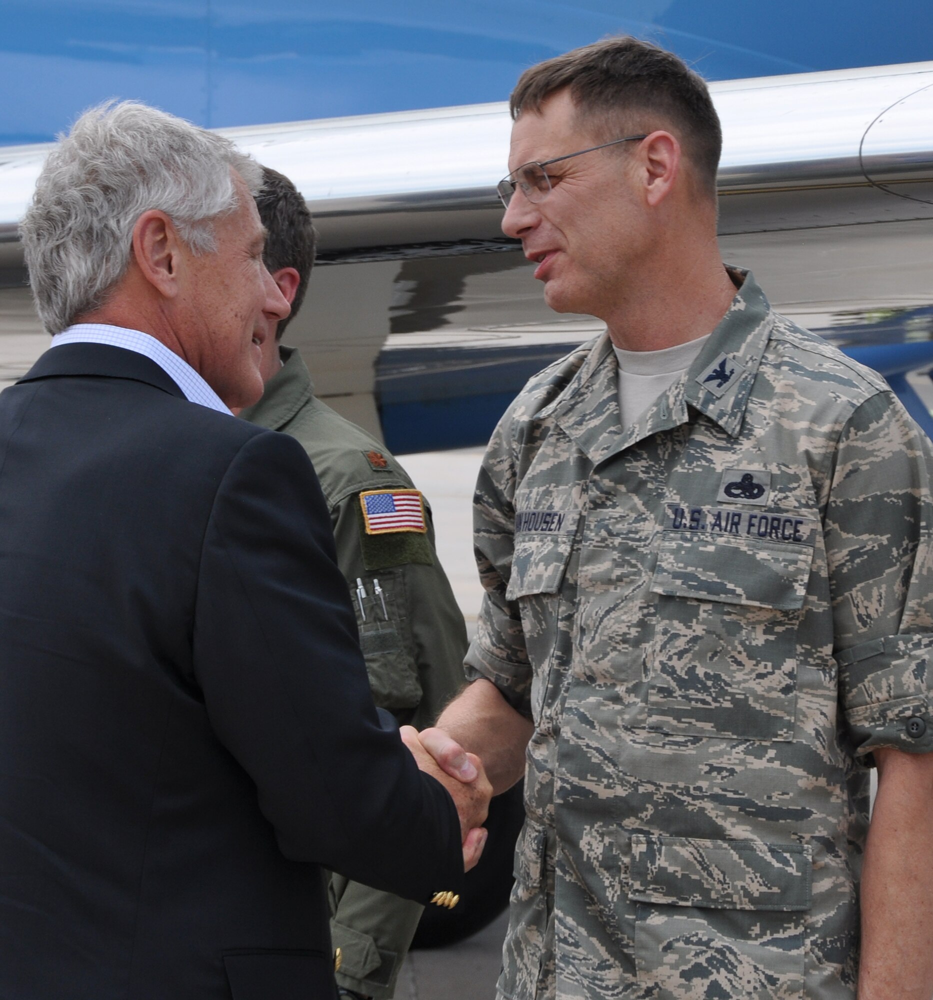 Secretary of Defense Chuck Hagel greets Air Force Reserve Col. James Van Housen June 28 on the Peterson Air Force Base flightline during the secretary's visit to Colorado Springs, Colo. Hagel met with maintainers and aircrew members from the 302nd Airlift Wing who were involved with Rocky Mountain aerial firefighting efforts using the Modular Airborne Fire Fighting System. Van Housen commands the 302nd Maintenance Group. (U.S. Air Force photo/Master Sgt. Daniel Butterfield)