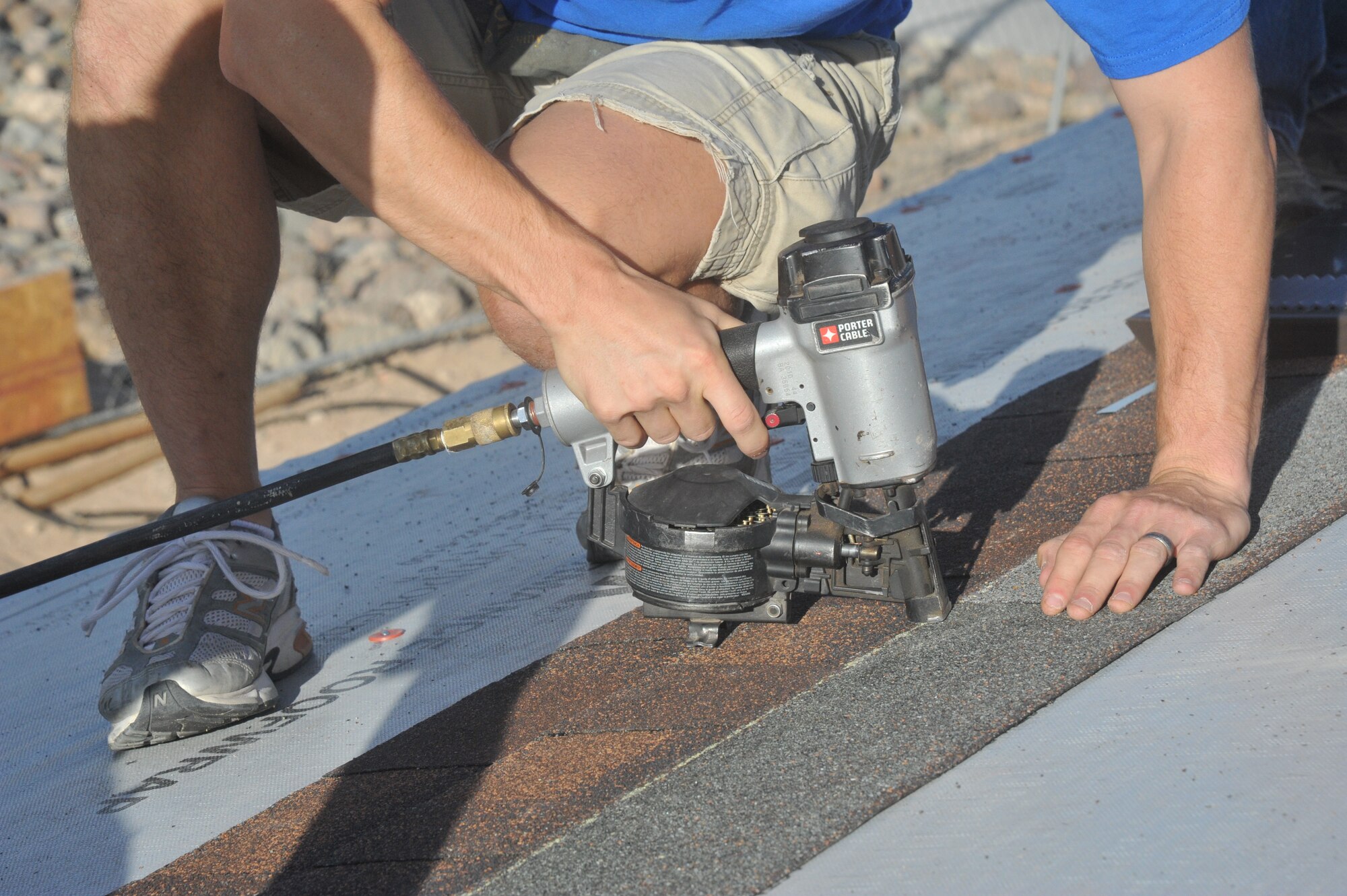 Capt. Brandon Roth, 62nd FS B flight commander, nails down a shingle Saturday during the construction of a house being built by HFH and volunteers. HFH is an ecumenical Christian housing organization welcoming people from all walks of life to partner in building and/or renovating homes for families in need.