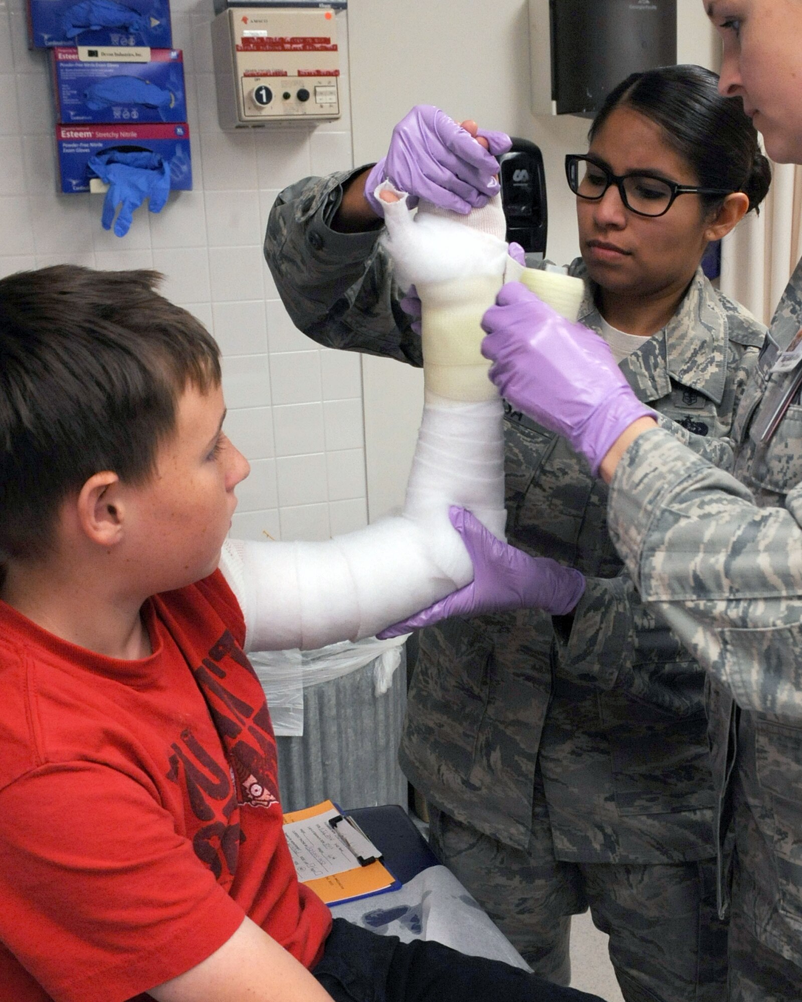 U.S. Air Force Tech. Sgt. Pamela Jirsa, 355th Medical Operations Squadron noncommissioned officer in charge of the orthopedics clinic, applies a cast to a patients arm at the 355th Medical Group clinic on Davis-Monthan Air Force Base, Ariz., June 27, 2013. Jirsa was accepted into the Nursing Enlisted Commissioning Program for the year of 2013. She will be released from regular duty for 24 months. During this time, they are required to obtain a Bachelor of Science degree in nursing, pass the National Council Licensure Examination and complete Commissioned Officer Training. (U.S. Air Force photo by Senior Airman Christine Griffiths/Released).