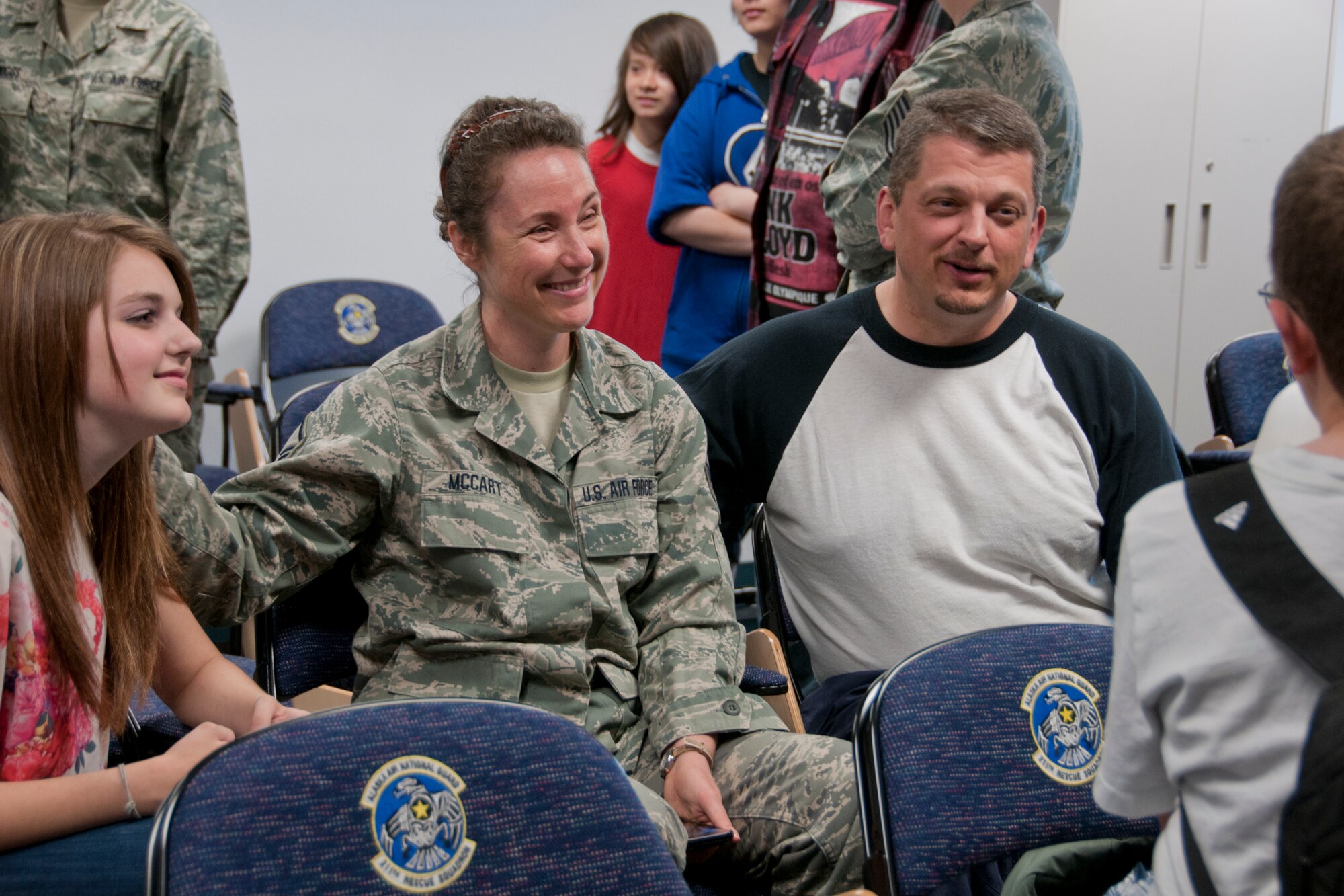 JOINT BASE ELMENDORF-RICHARDSON, Alaska -- Master Sgt. Rebecca McCart, the customer support  supervisor of the 176 Logistics Readiness Squadron, says farewell to her family here June 26, 2013, before she leaves on deployment. Nearly 100 air guardsmen from across the 176 Wing, mostly from the 176 Maintenance Group and 176 Operations Group, left for Kuwait in support of Operation Enduring Freedom. National Guard photo by Staff Sgt. N. Alicia Halla.