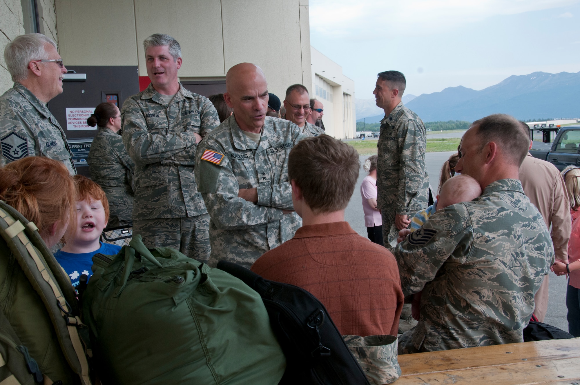 JOINT BASE ELMENDORF-RICHARDSON, Alaska -- Alaska air guardsmen say farewell to their friends, families and coworkers here June 26, 2013, before they leave on deployment. Nearly 100 air guardsmen from across the 176 Wing, mostly from the 176 Maintenance Group and 176 Operations Group, left for Kuwait in support of Operation Enduring Freedom. National Guard photo by Staff Sgt. N. Alicia Halla.