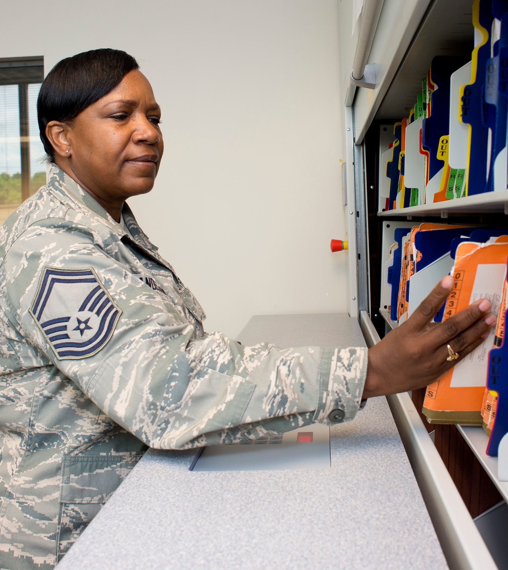 U.S. Air Force Senior Master Sgt. Maldvina Anderson, health services manager, 116th Air Control Wing, Georgia Air National Guard (ANG), files member’s medical records, June 11, 2013.  Anderson works in the 116th Medical Group as a full-time dual-status civil service employee whose position is tied to an ANG military position. (U.S. Air National Guard photo by Master Sgt. Roger Parsons/Released)