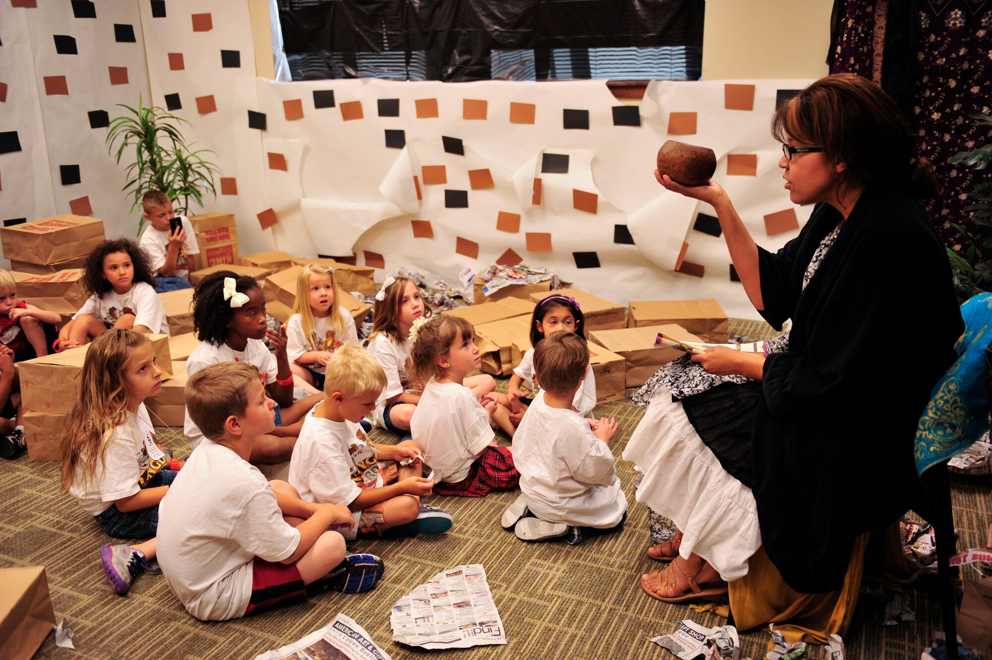 Kristine Hazelett, Vacation Bible School volunteer and wife of Tech. Sgt. Robert Hazelett, 140th Wing Public Affairs, demonstrates an example from the Bible June 26, 2013, at the chapel on Buckley Air Force Base, Colo. The VBS curriculum included several types of learning styles such as singing, dancing, acting, and arts and crafts. (U.S. Air Force photo by Airman 1st Class Darryl Bolden Jr./Released) 