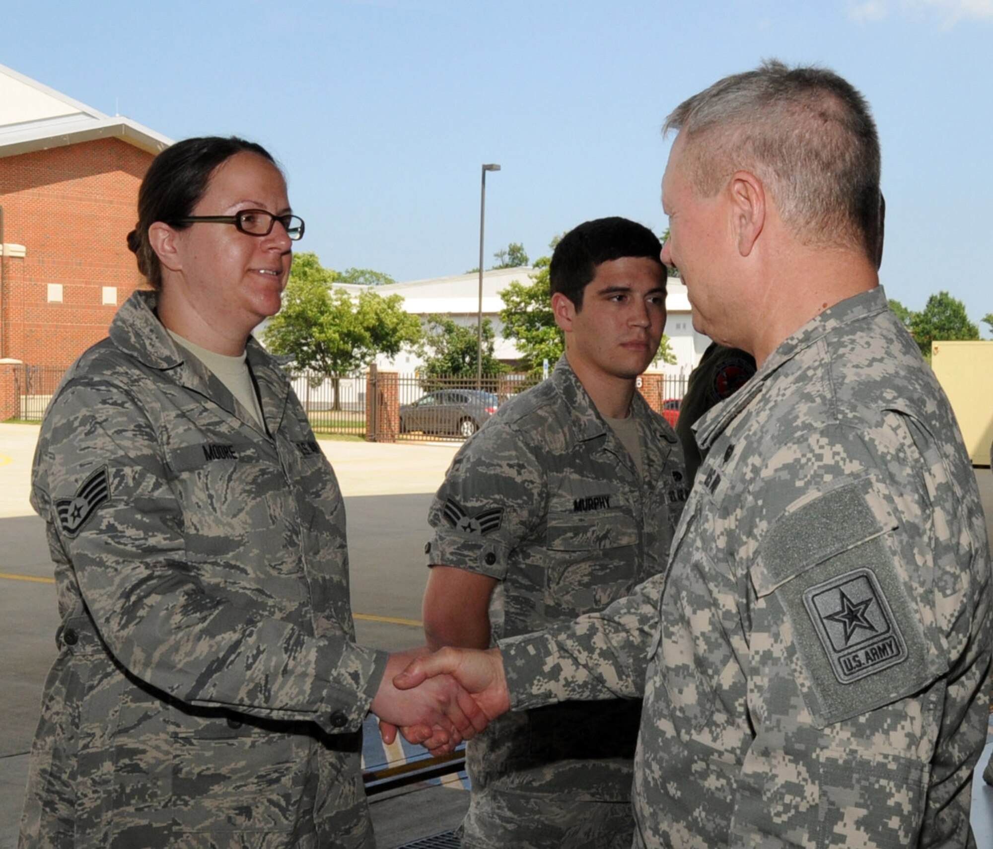 U.S. Army Gen. Frank J. Grass (right), chief of the National Guard Bureau, presents Air Force Staff Sgt. Alyson Moore, 192nd Fighter Wing aircraft maintenance specialist, with his personal challenge coin at Joint Base Langley-Eustis, Va., June 15, 2013.  Moore was integral in providing training to both active duty and Guard members on correcting aircraft forms for the F-22 Raptor Low Observable Sections Data Integrity system, documentation errors.  She also assisted with the development of a new handheld Outer Mold Line (OML) device, and was instrumental in the creation of a standardized documentation plan for inputting aircraft OML damages into Air Force Maintenance Information System databases. (U.S. Air National Guard photo by Master Sgt. Carlos J. Claudio/Released)