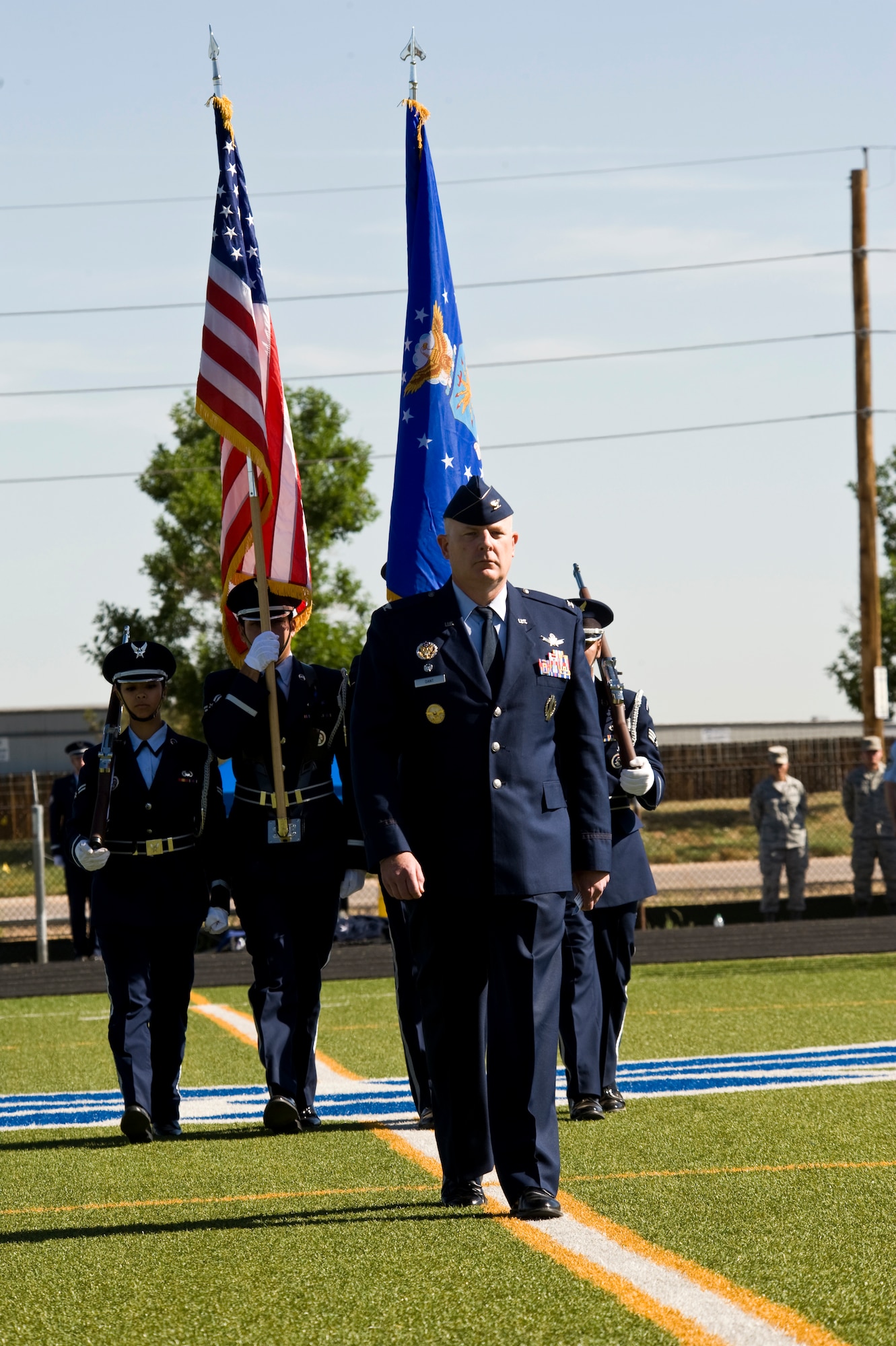 Col. Dan A. Dant, former 460th Space Wing commander, marches with the colors during the 460th SW change of command ceremony June 28, 2013, on Buckley Air Force Base, Colo. Dant was relinquished of command after two years as the wing commander allowing Col. Daniel D. Wright III to step in as the new commander. (U.S. Air Force photo by Senior Airman Phillip Houk/Released)