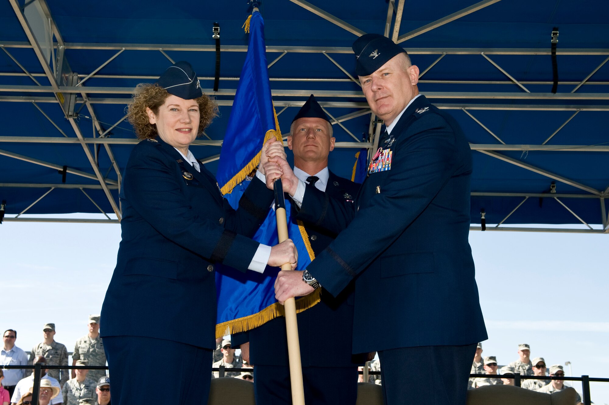 Lt. Gen. Susan J. Helms, 14th Air Force commander, retrieves the 460th Space Wing guidon from Col. Dan A. Dant June 28, 2013, during the 460th SW change of command ceremony on Buckley Air Force Base, Colo. This event marked the end of Dant's two years of command. (U.S. Air Force photo by Senior Airman Phillip Houk/Released)
