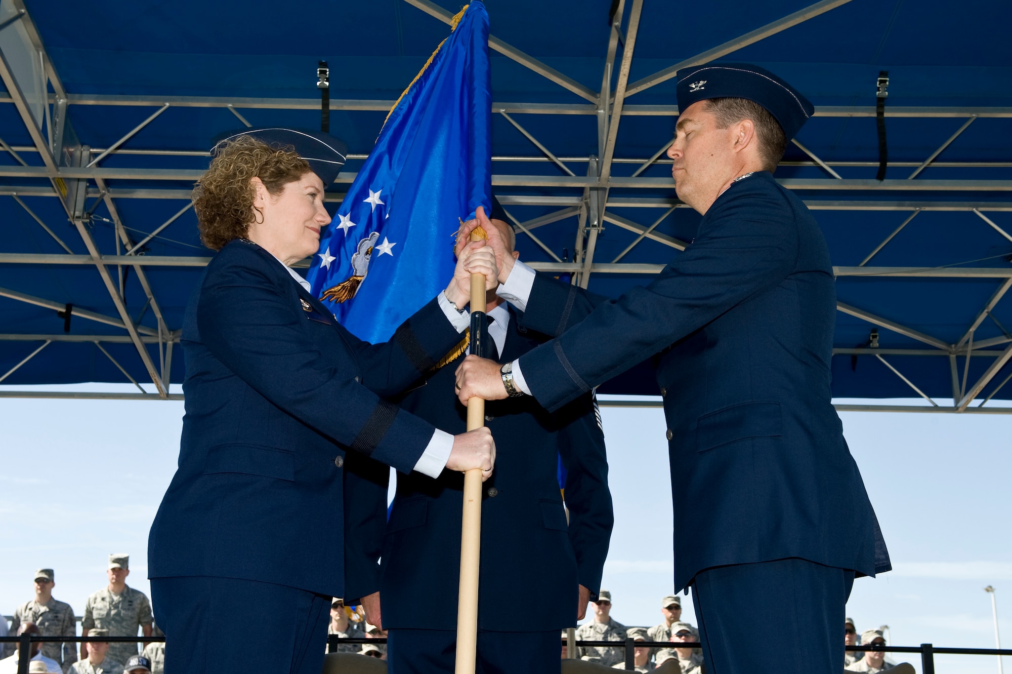 Lt. Gen. Susan J. Helms, 14th Air Force commander presents the 460th Spaec Wing wing guidon to Col. Daniel D. Wright III symbolizing his assumption of command as the 460th SW commander June 28, 2013, during the 460th SW change of command ceremony on Buckley Air Force Base, Colo. Wright previously led the Space Operations Group at Aerospace Data Facility-Southwest. (U.S. Air Force photo by Senior Airman Phillip Houk/Released)