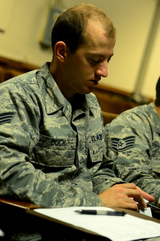 U.S. Air Force Senior Airman Brent Buck, 633rd Civil Engineer Squadron civil engineer, examines examples of identification cards during a training session at Langley Air Force Base, Va., June 28, 2013. As entry control support personnel for the 633rd Security Forces Squadron, Airmen are trained on credentials, safe havens, Department of Defense shipments coming on base, political asylum situations and closures due to emergencies. (U.S. Air Force photo by Senior Airman Kayla Newman/Released)