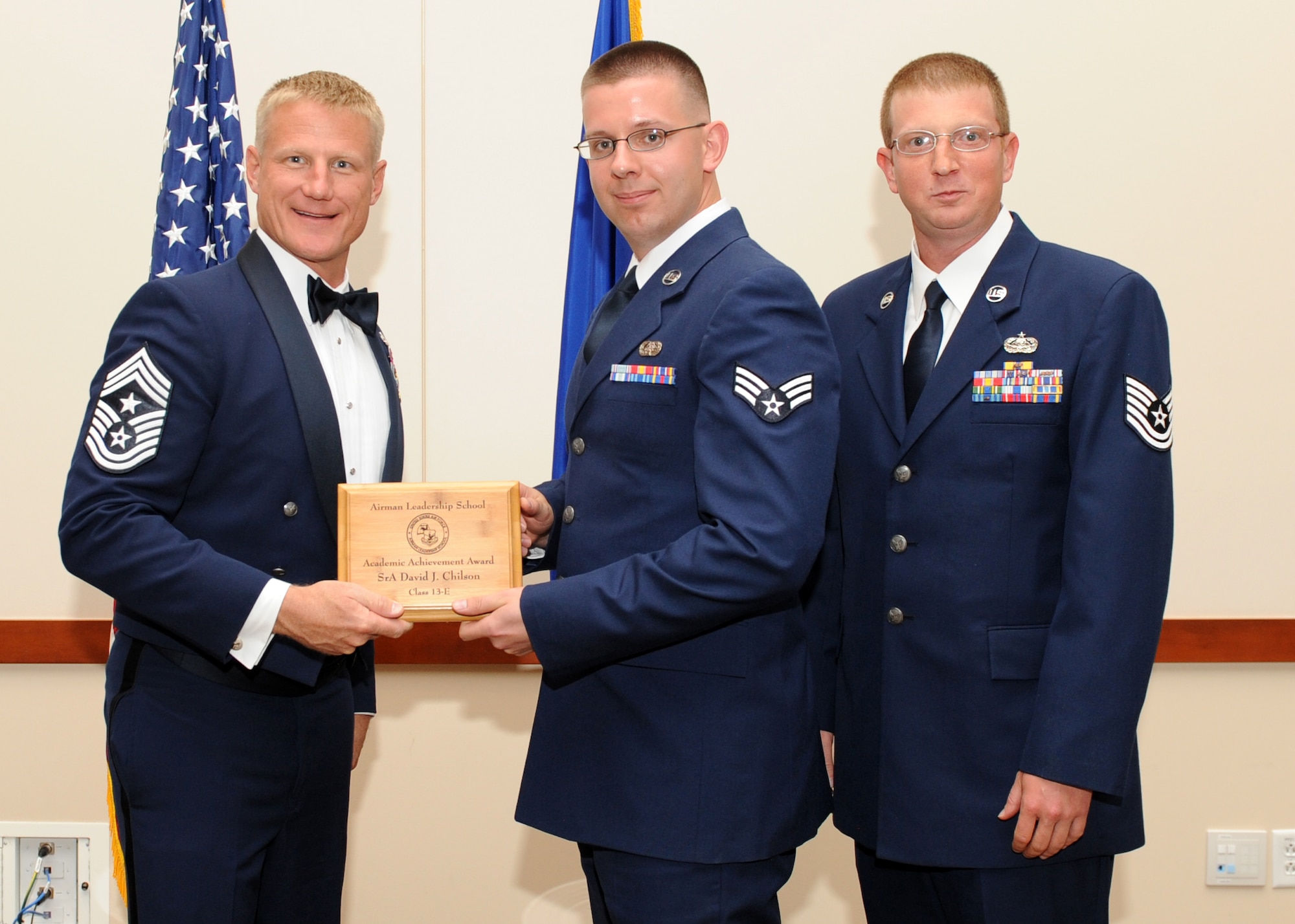 Senior Airman David Chilson, 460th Space Communications Squadron, receives the academic achievement award, during the graduation of Buckley Airman Leadership School Class 13E June 27, 2013, at Buckley Air Force Base, Colo. The academic award is awarded to the student with the highest overall average on all academic evaluations during ALS. (U.S. Air Force photo by Senior Airman Marcy Glass/Released)
