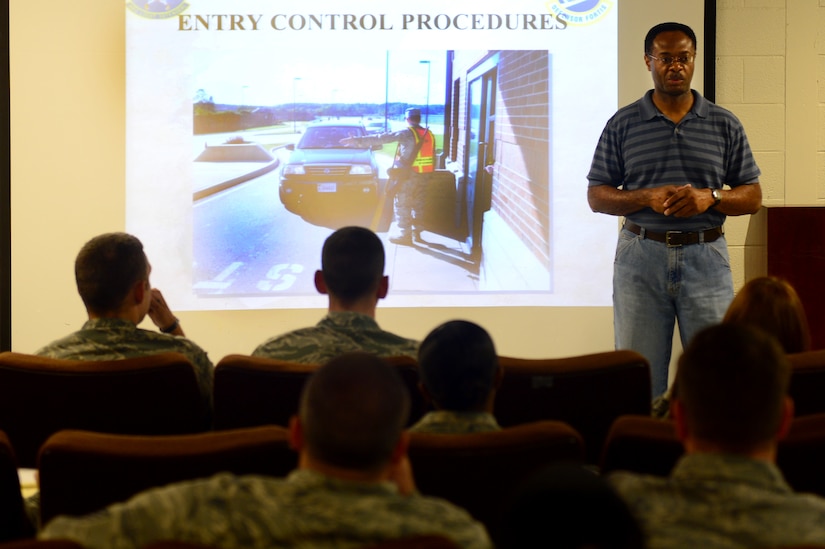 Abraham Smith, 633rd Security Forces Squadron trainer, conducts entry control training at Langley Air Force Base, Va., June 28, 2013. Airmen are selected to perform the entry control support detail to ensure morning traffic is processed on the base in a timely manner. (U.S. Air Force photo by Senior Airman Kayla Newman/Released)