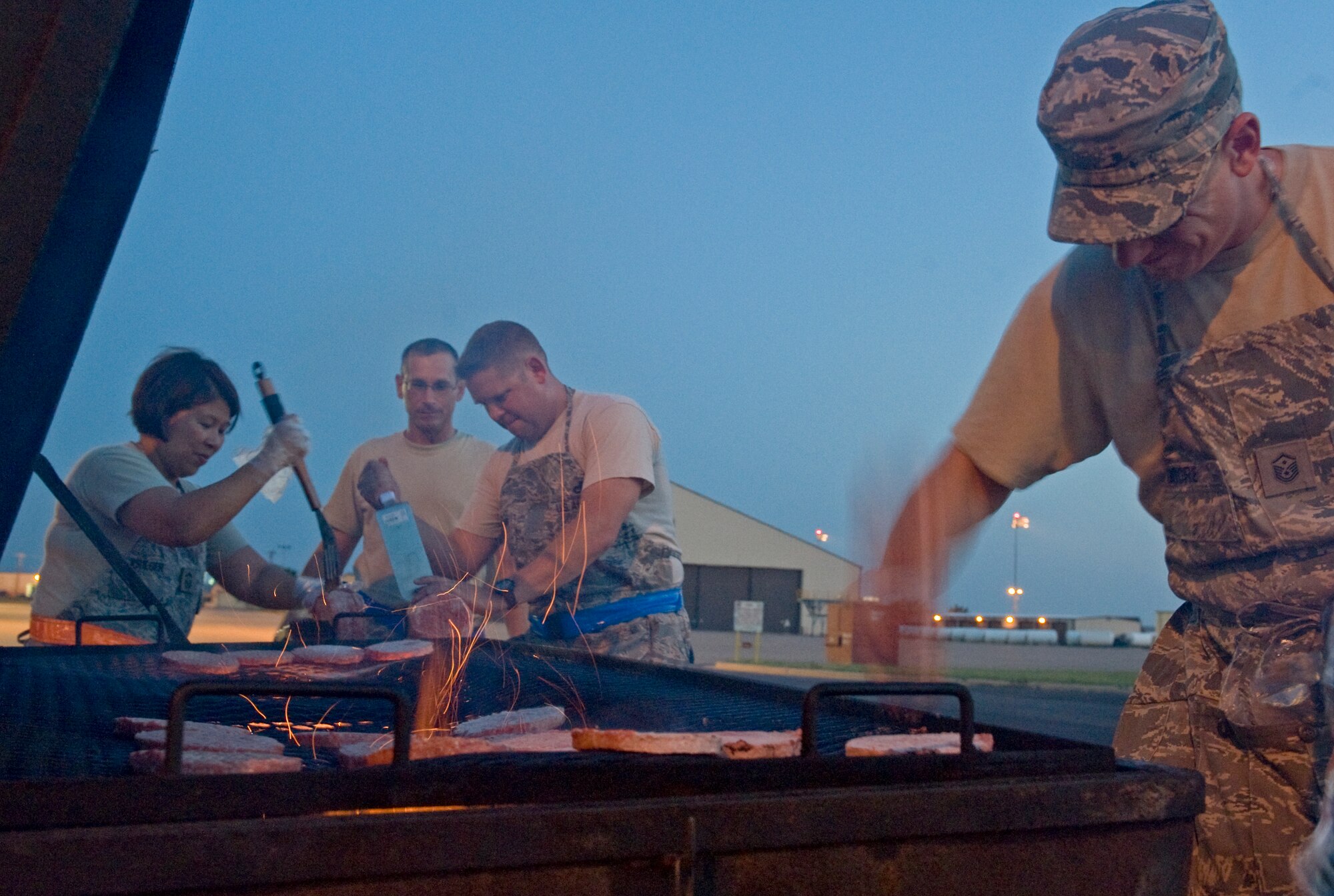 Dyess first sergeants separate frozen meat in preparation for a burger burn June 26, 2013, at Dyess Air Force Base, Texas. During the burger burn, first sergeants grilled hamburgers and hotdogs for a large number of night shift Airmen. (U.S. Air Force photo by Airman 1st Class Peter Thompson/Released)