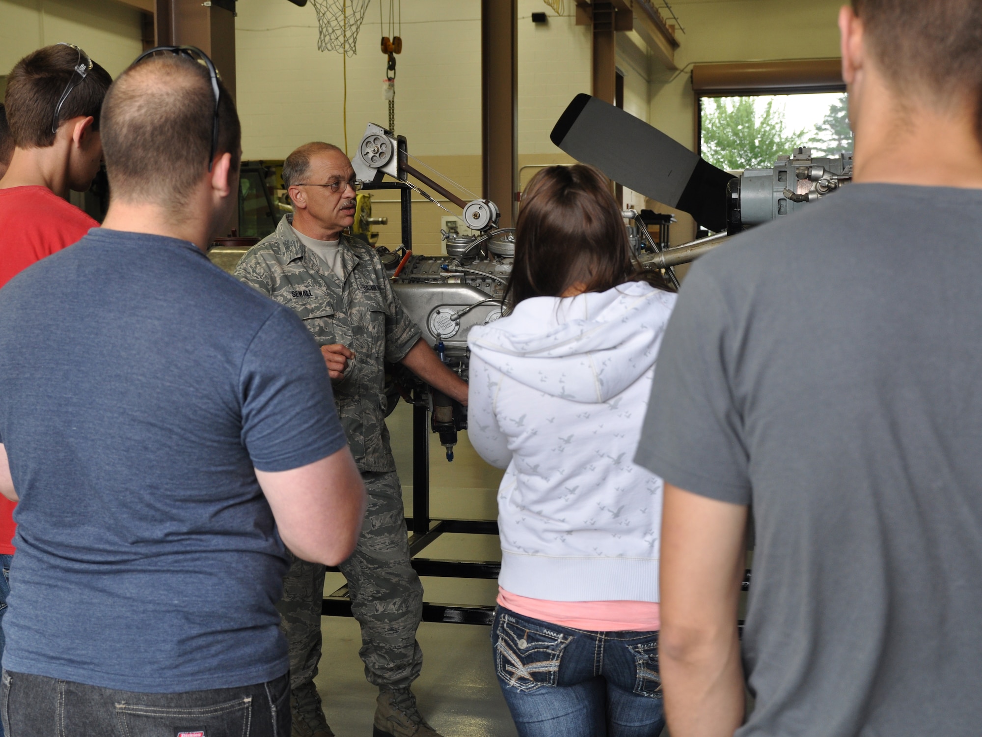 YOUNGSTOWN AIR RESERVE STATION, Ohio—Air Force Reserve Technical Sgt. Ben Sewall, II, an aerospace propulsion craftsman with the 910th Maintenance Squadron, discusses the mechanics of a C-130H Hercules engine with students from the Pittsburgh Institute of Aeronautics, Friday, June 28, here. The students were here to gain a hands-on experience with military aviation technology and practices/ They visited the propulsion shop, a C-130H Hercules aircraft and YARS’ aerial spray maintenance shop. YARS is home to the Department of Defense’s only large-area fixed-wing aerial spray capability. U.S. Air Force photo by Mr. Eric M. White