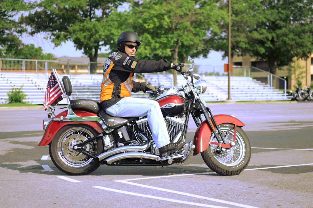 Green Knights Chapter 20 President Chris Orbits rides his Harley-Davidson motorcycle while in attendance for Team Andrews Motorcycle Safety Day here Friday, June 28. The Green Knights attend many motorcycle related events in an effort to increase safety awareness. (U.S. Air Force Photo by Airman 1st Class Joshua R. M. Dewberry)