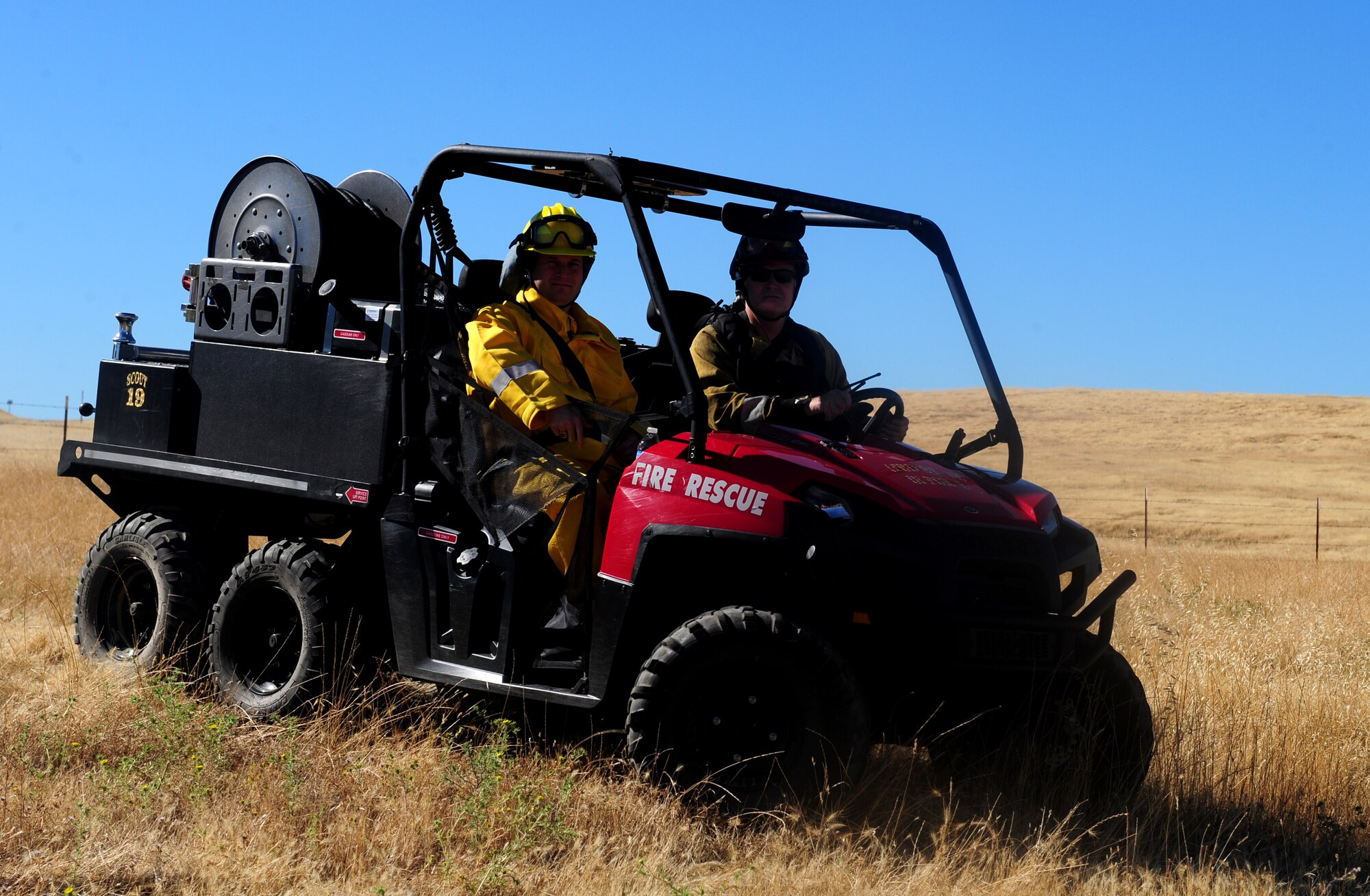Col. Phil Stewart (left), 9th Reconnaissance Wing commander, rides in an off-road scout vehicle during a prescribed burn exercise at Beale Air Force Base, Calif., June 27, 2013. A prescribed burn is used to combat potential wild fires. (U.S. Air Force photo by Airman 1st Class Bobby Cummings/Released)