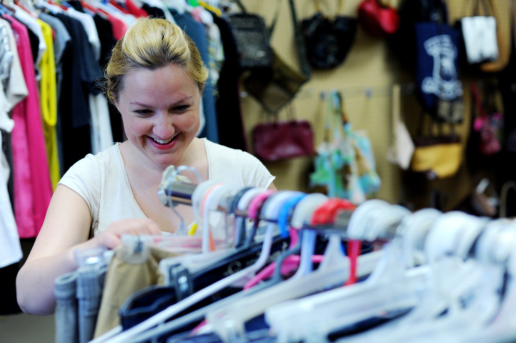 Simona Millar, wife of Staff Sgt. Andrew Millar, 353rd  Combat Training Squadron intelligence analyst, sorts clothing at the Airman’s Attic June 20, 2013, Eielson Air Force Base, Alaska. Volunteers sort through donations to guarantee only quality items are received by the public. (U.S. Air Force photo by Staff Sgt. Jim Araos/Released)