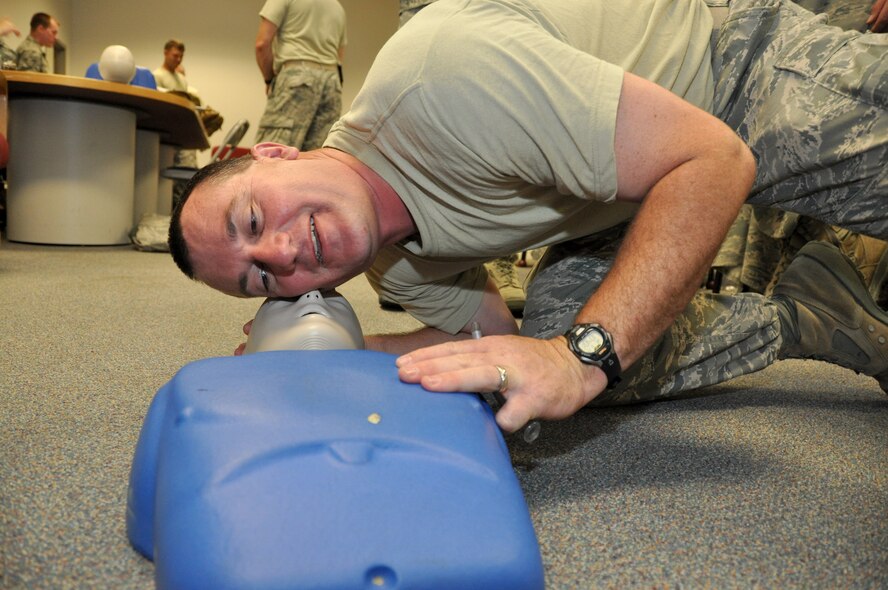 Staff Sgt. Kevin Gerke simulates checking a casualty for breathing during self-aid buddy care hands-on training, June 19, 2013. The 442nd CES completed their annual tour training here, which consisted of work orders, classroom and field training and land navigation. The 442nd CES is part of the 442nd Fighter Wing, an A-10 Thunderbolt II Air Force Reserve unit at Whiteman Air Force Base, Mo. (U.S. Air Force photo by Senior Airman Wesley Wright/Released)
