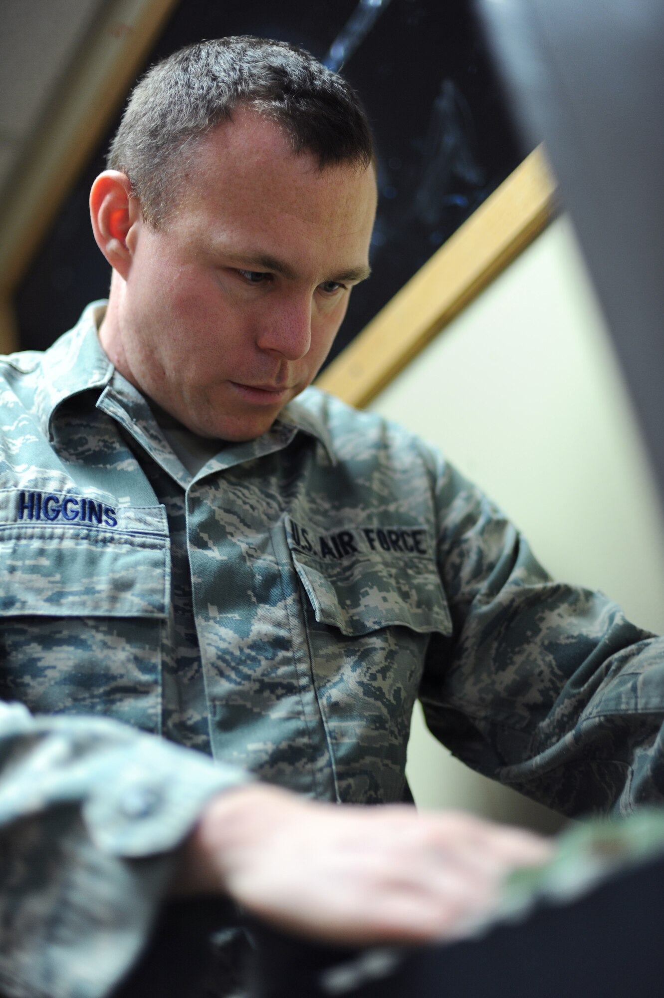 U.S. Air Force Senior Airman Jonathan Higgins, 354th Logistics Readiness Squadron vehicle maintainer, sorts paperwork at the Airman’s Attic June 20, 2013, Eielson Air Force Base, Alaska. Airman’s Attic volunteers ensure that each customer follows guidelines of acquiring free items. (U.S. Air Force photo by Staff Sgt. Jim Araos/Released)