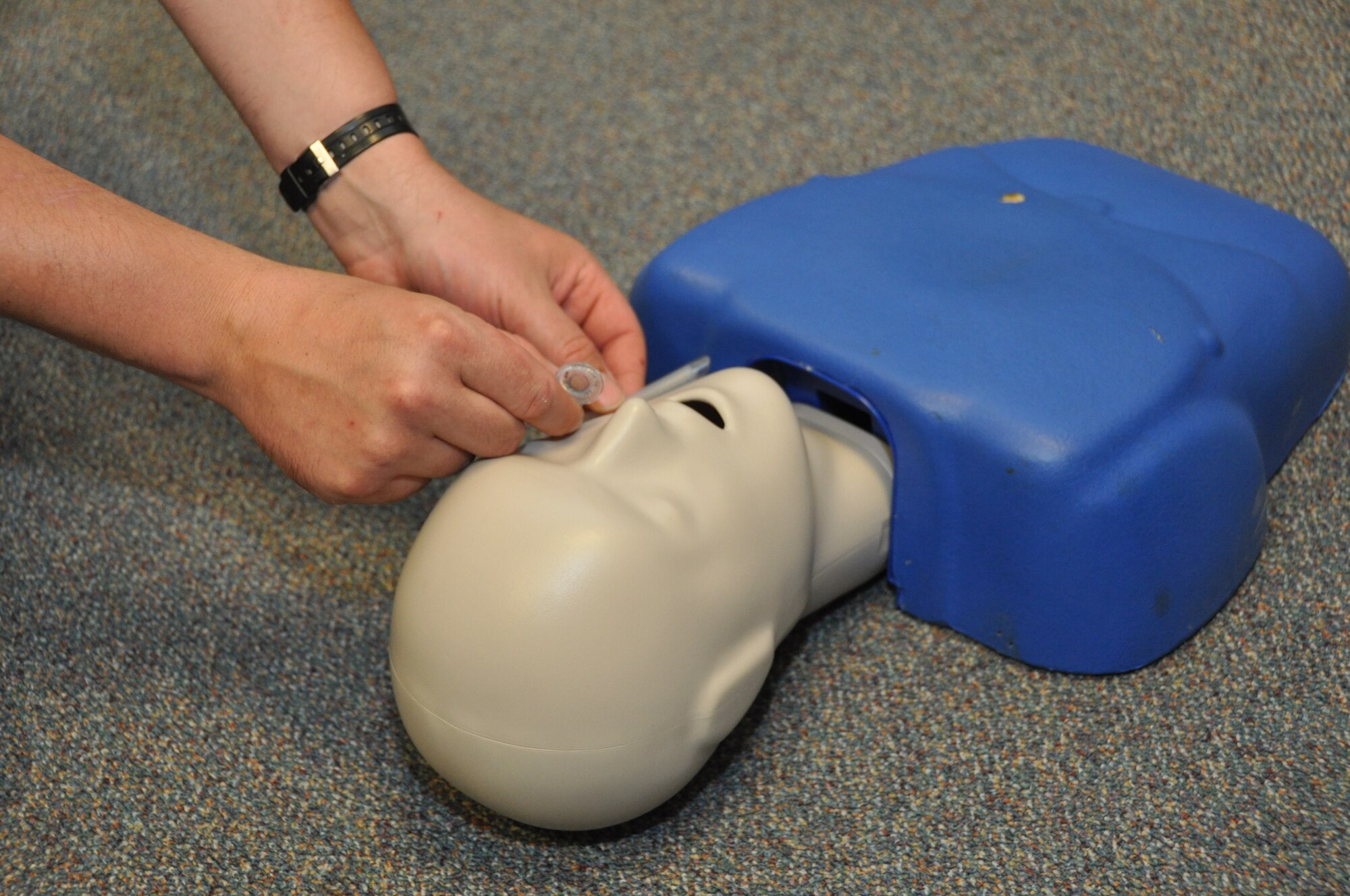 An Airman with the 442nd Civil Engineer Squadron practices inserting a nasal breathing tube, during self-aid buddy care hands-on training, June 19, 2013. The 442nd CES completed their annual tour training here, which consisted of work orders, classroom and field training and land navigation. The 442nd CES is part of the 442nd Fighter Wing, an A-10 Thunderbolt II Air Force Reserve unit at Whiteman Air Force Base, Mo. (U.S. Air Force photo by Senior Airman Wesley Wright/Released)