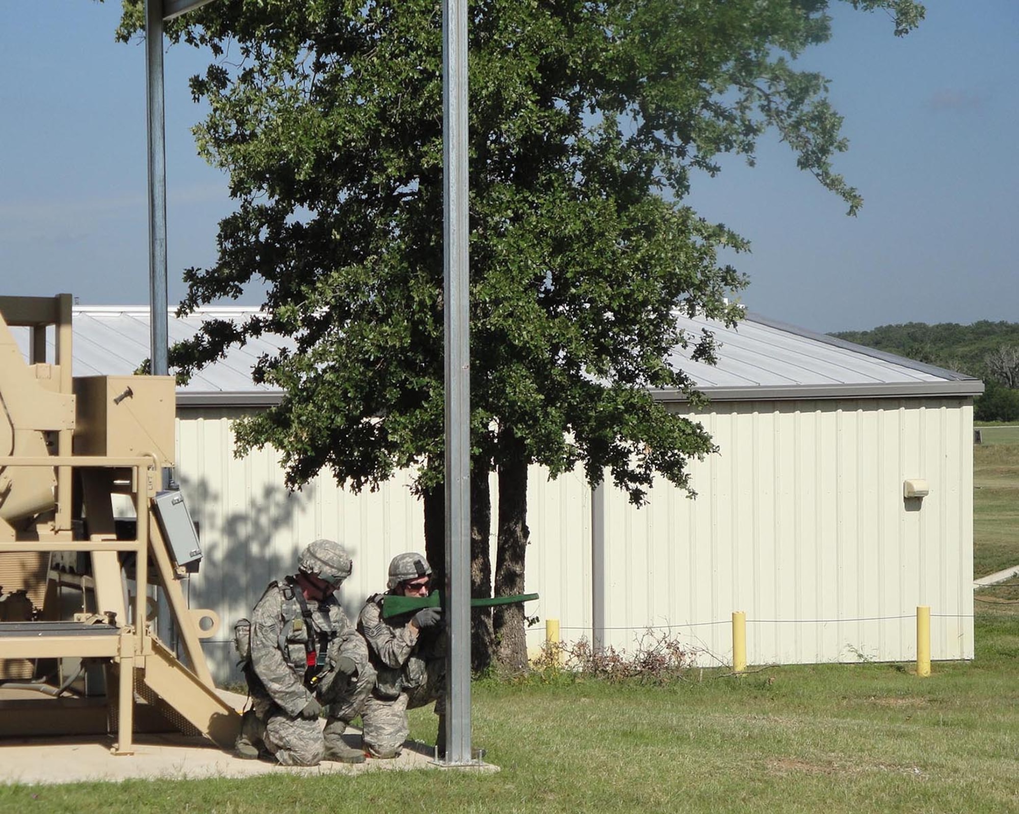 Senior Airman Joshua Bingham (left) and Staff Sgt. Ryan Hogan, 446th Security Forces Squadron, Joint Base Lewis-McChord, Wash., defend their position following a simulated Humvee rollover during Patriot Defender training at Fort Wolters, Texas June 8-23 (Courtesy photo)