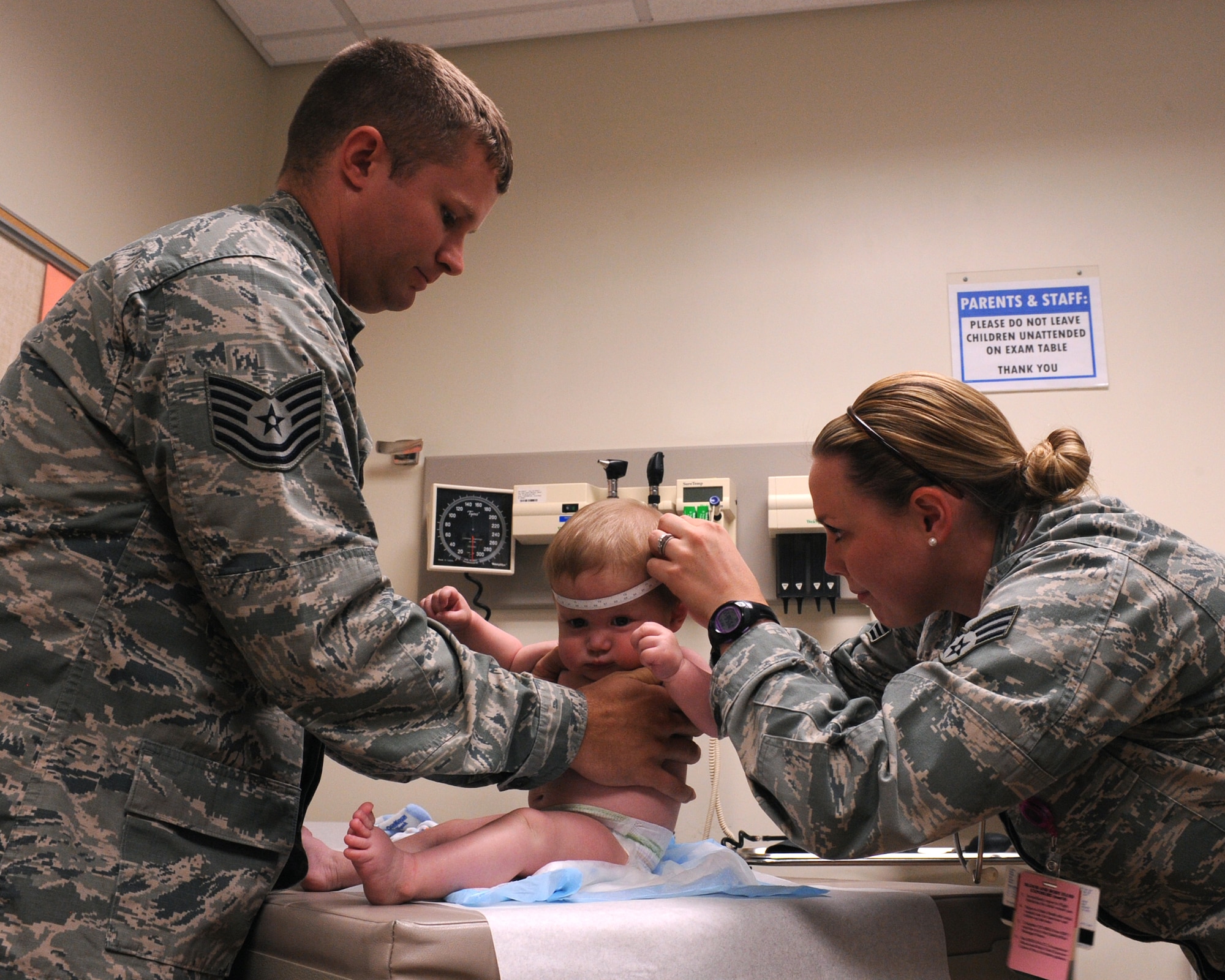 U.S. Air Force Senior Airman Brittany Harmening, 355th Medical Operations Squadron aerospace medical technician, measures an infant patient's head at the 355th Medical Group at Davis-Monthan Air Force Base, Ariz., June 26, 2013. The 355th MDOS provides medical care to maximize the health and welfare of current and retired warriors and their family members, both in theater and at home.  (U.S. Air Force photo by Senior Airman Christine Griffiths/Released)