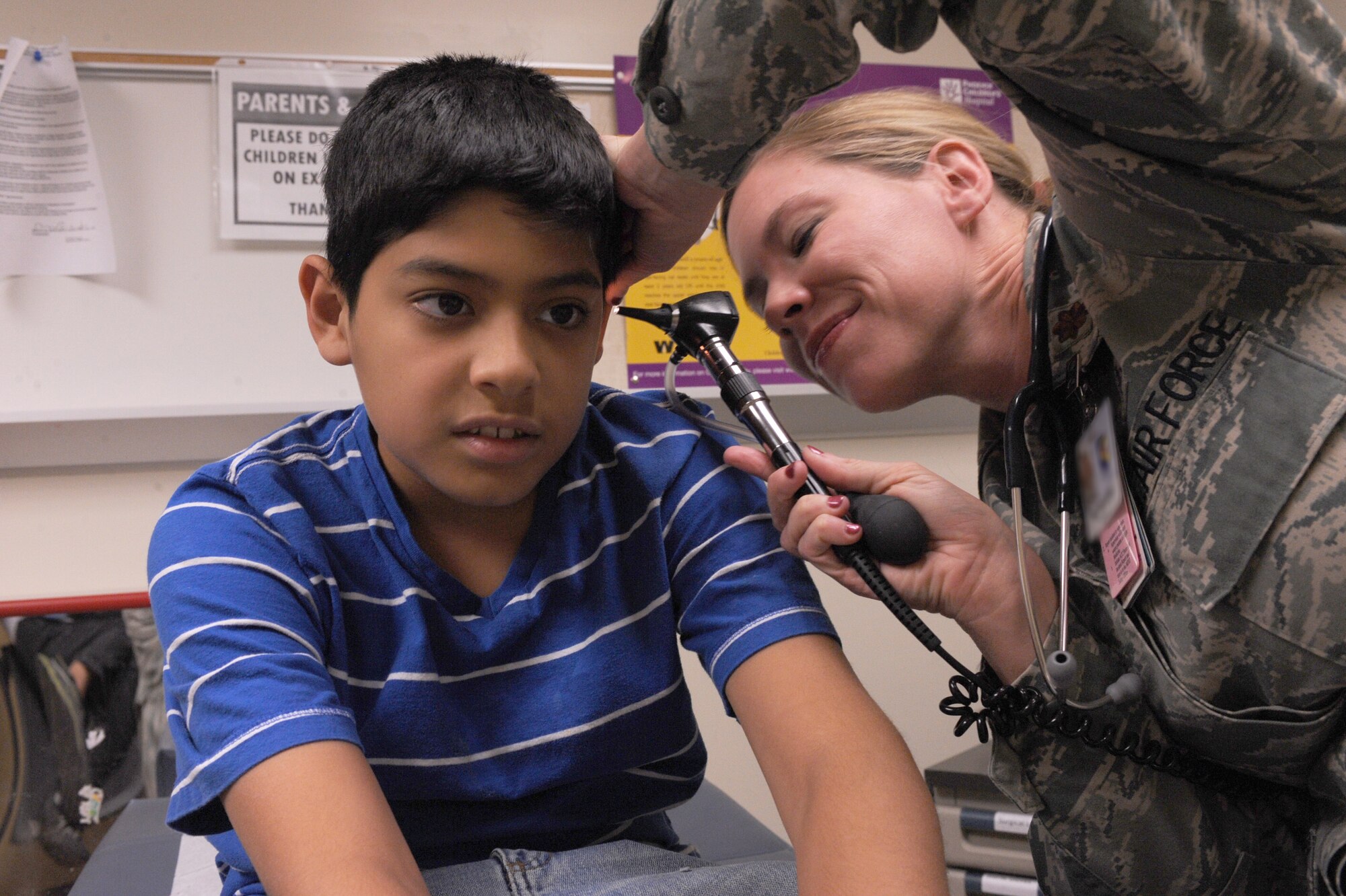 U.S. Air Force Maj. Erin Burris, 355th Medical Operations Squadron pediatric physician, examines a patient at the 355th Medical Group at Davis-Monthan Air Force Base, Ariz., June 26, 2013. The 355th MDOS ensures combatant commanders that their warfighters are medically fit-to-fight and provides combat-ready medical personnel to execute medical support of missions worldwide. (U.S. Air Force photo by Senior Airman Christine Griffiths/Released)