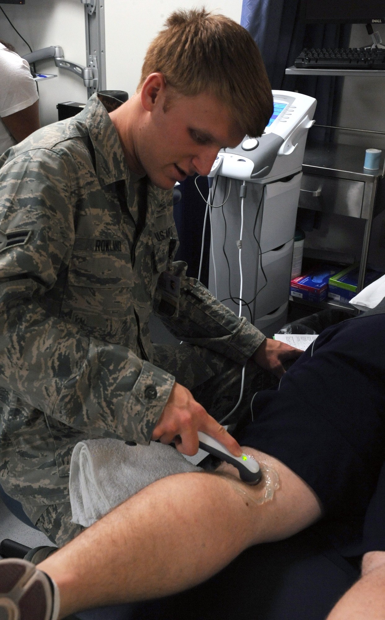 U.S. Air Force Airman 1st Class Cameron Rowland, 355th Medical Operations Squadron, uses an ultrasound machine on a patient at the physical therapy clinic at Davis-Monthan Air Force Base, Ariz., June 26, 2013. The ultrasound is used to heat and break up scar tissue, reduce inflammation, and ease muscle spasms. (U.S. Air Force photo by Senior Airman Christine Griffiths/Released) 