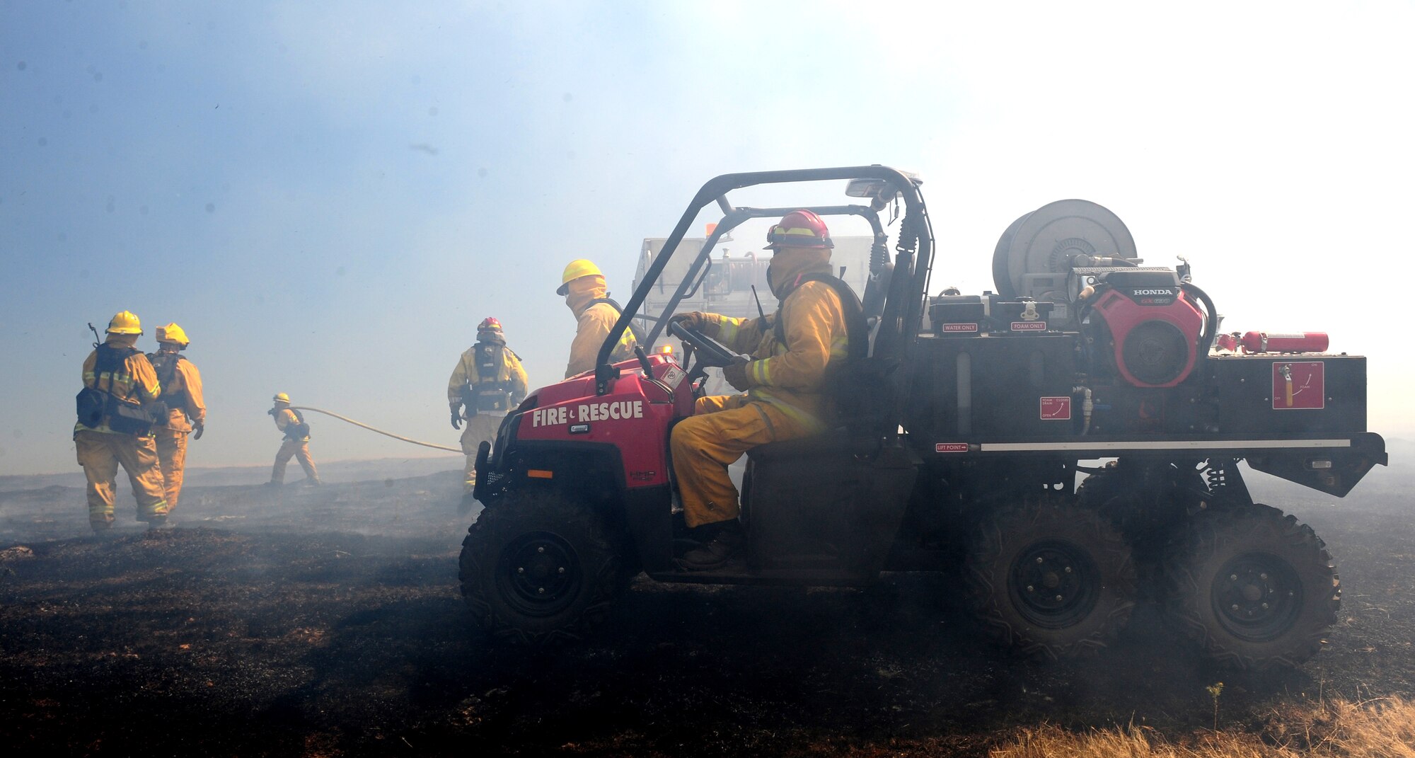 Beale Airmen utilize a multitude of vehicles to contain a prescribed burn at the M-60 firing range on Beale Air Force Base, Calif., June 27, 2013. The M-60 range here is more susceptible to fires due to sparks from the constant firing of weapons. (U.S. Air Force photo by Airman 1st Class Bobby Cummings/Released)