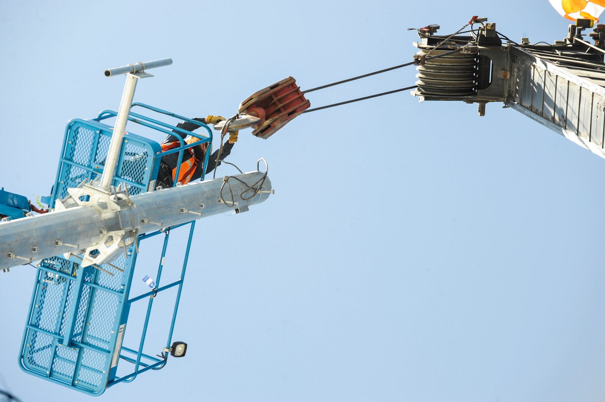 A DWG and Associates contractor unhooks a cable from a 100-foot communication mono pole June 21, 2013, on Buckley Air Force Base, Colo. The 460th Space Communication Squadron’s newest communication pole will allow for signals to be received and transmitted five times further than previously done. (U.S. Air Force photo by Staff Sgt. Christopher Gross/Released)
