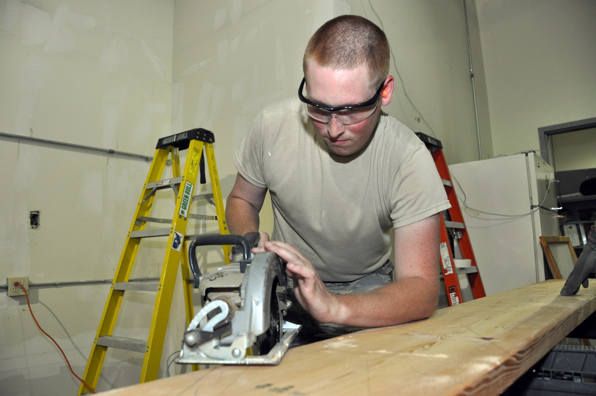 (130618-F-PL517-023) Airman Nicholas Schlittler, 442nd Civil Engineer Squadron structures technician, saws the rough edges off stair risers during annual tour training June 18, 2013. Members of the 442nd CES train regularly in skills they will use while deployed The 442nd CES is part of the 442nd Fighter Wing, an A-10 Thunderbolt II Air Force Reserve unit at Whiteman Air Force Base, Mo. (U.S. Air Force photo by Senior Airman Wesley Wright/Released)