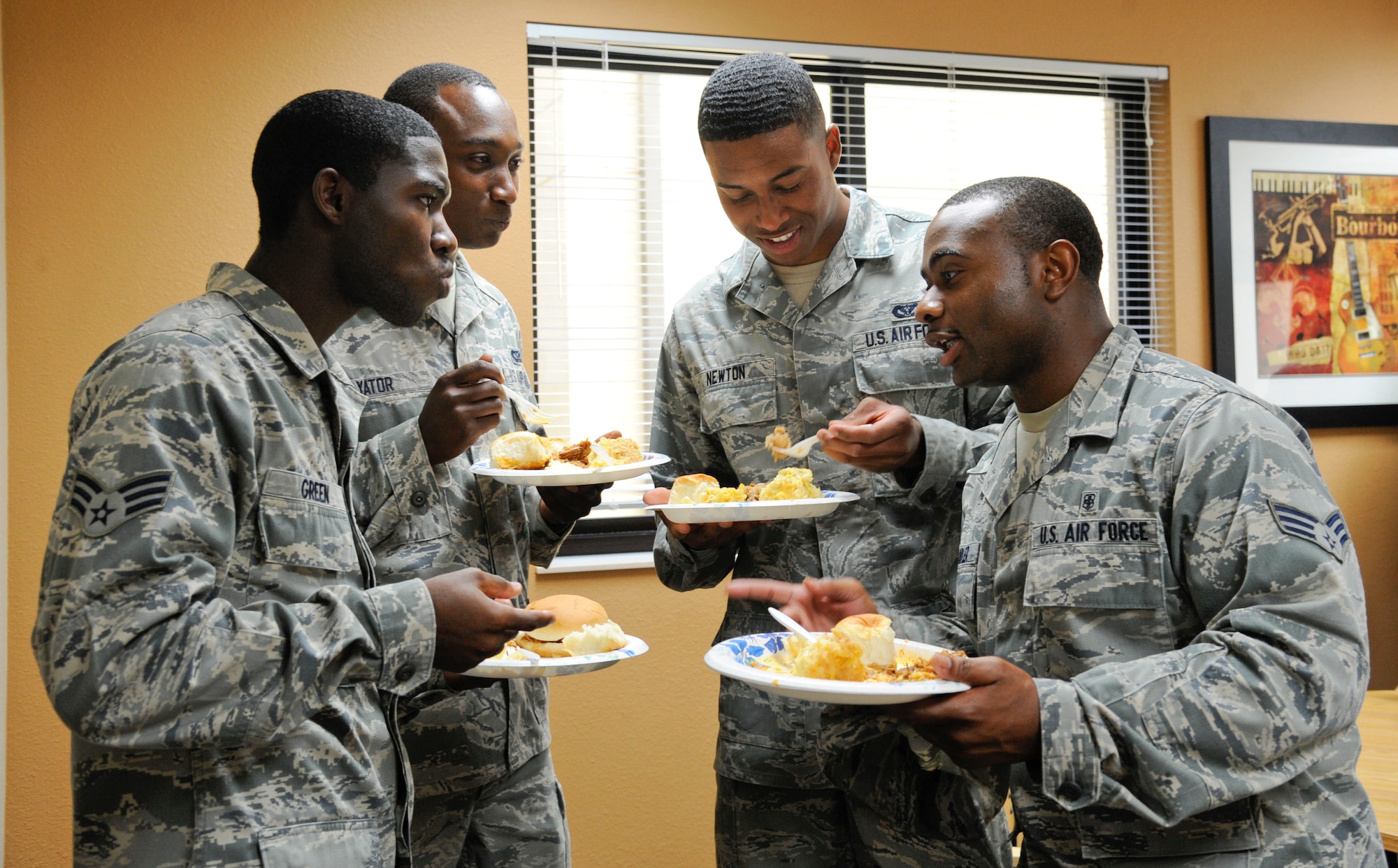 Airmen converse during the Almost Mama's Home Cooking dormitory potluck on Barksdale Air Force Base, La., June 20, 2013. The potluck was organized by Barksdale's Top III to show appreciation to Airmen and boost morale. (U.S. Air Force photo/Airman 1st Class Andrew Moua)